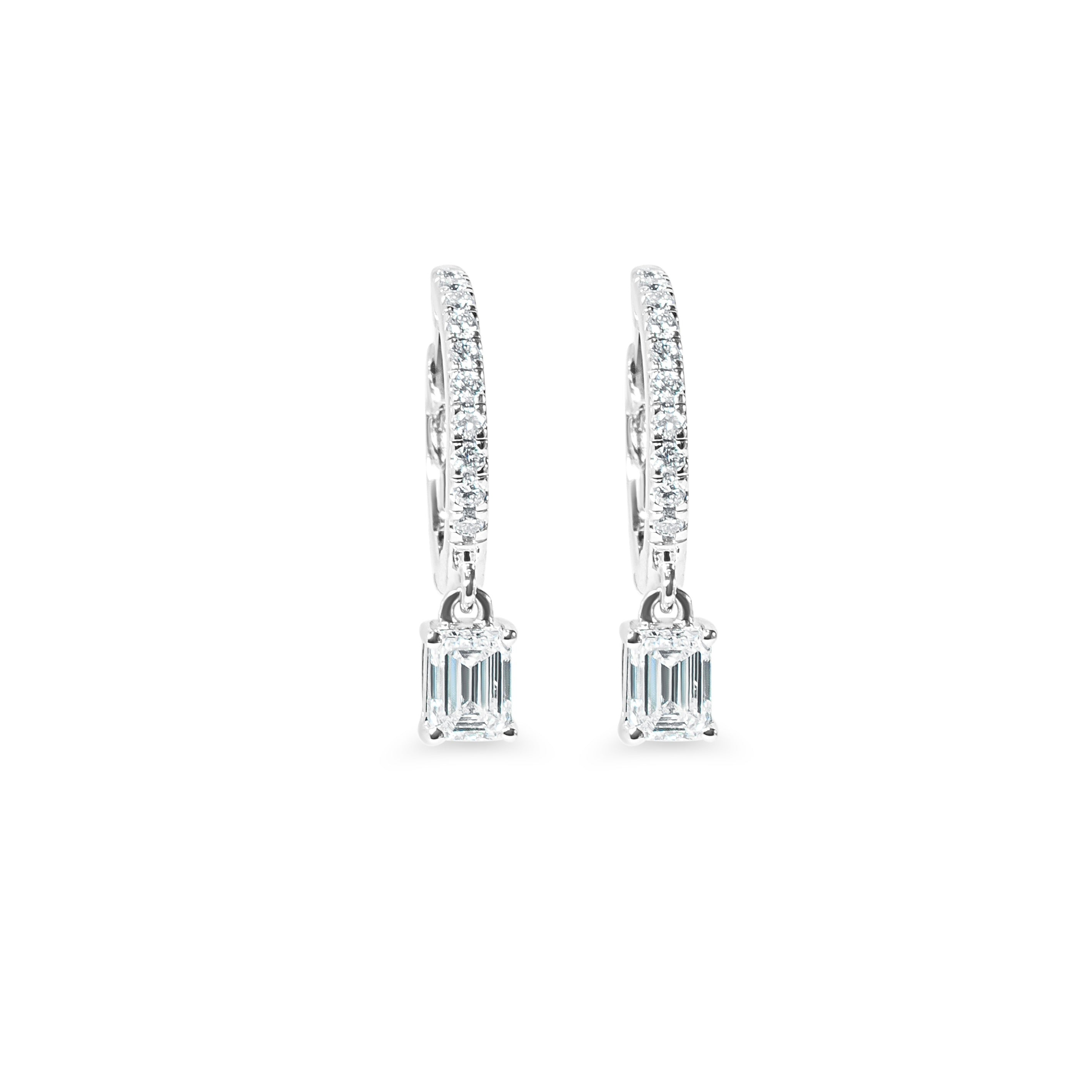 Pair of diamond huggie earrings on a white background