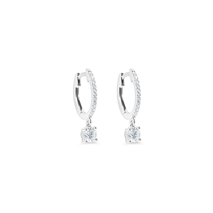 Pair of diamond huggie earrings on a white background