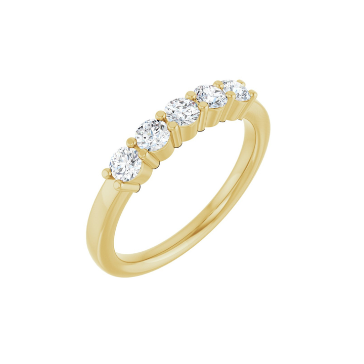 Gold ring with five diamonds on a white background