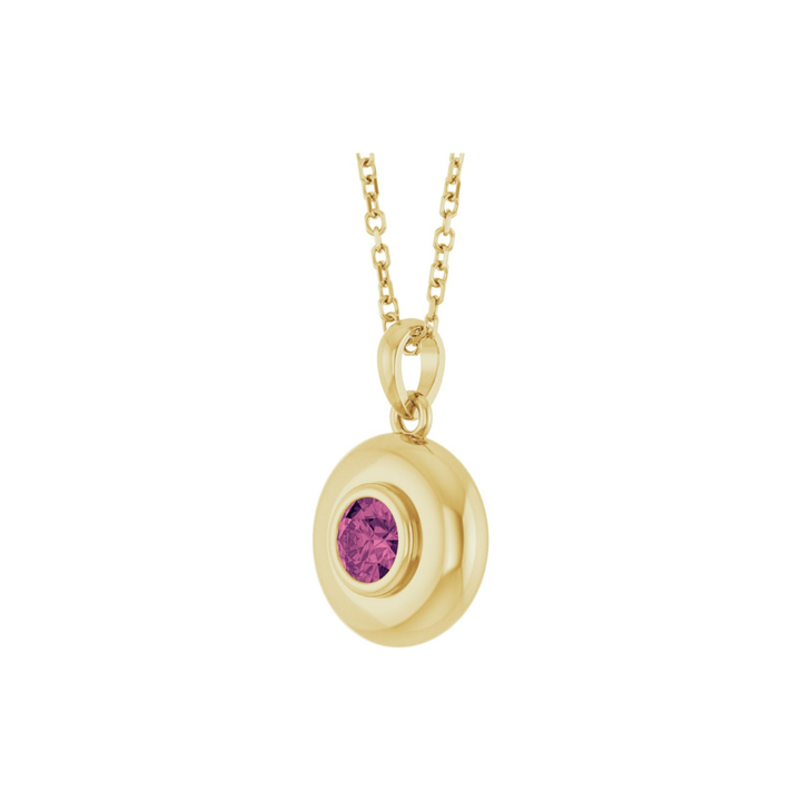 Gold pendant with a pink tourmaline on a white background