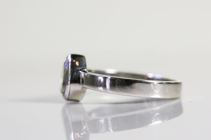 Side view of the ring. The band is polished and has high shine, and it is the same thickness all the way around.