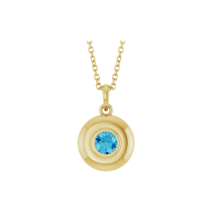 Gold necklace with a blue zircon pendant on a white background