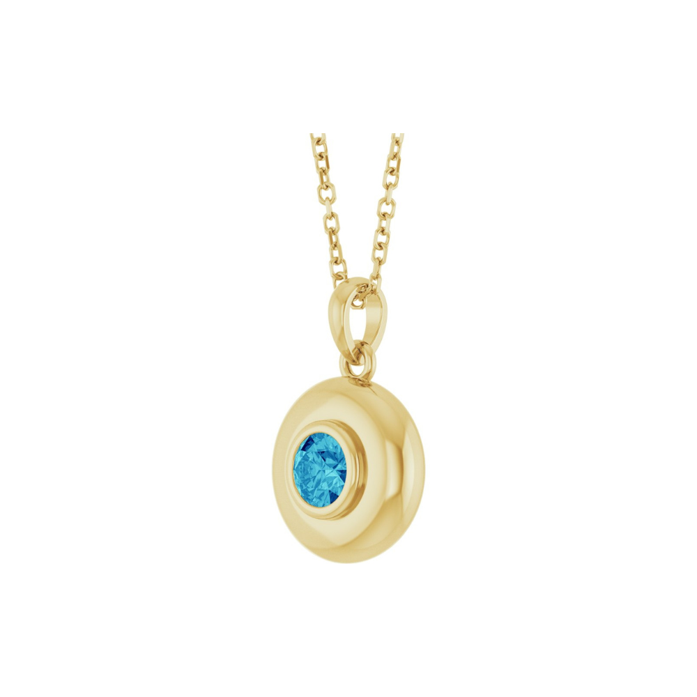 Gold necklace with a blue zircon pendant on a white background