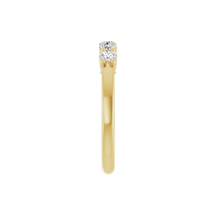 Gold ring with five diamonds on a white background