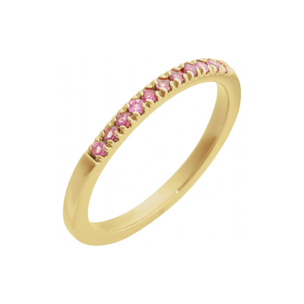 Gold ring with pink tourmalines on a white background
