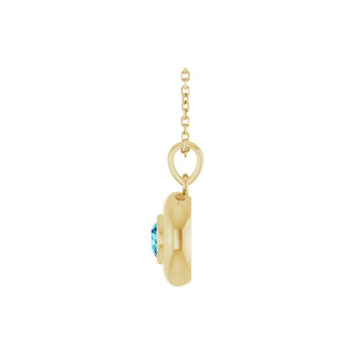 Gold necklace with a blue zircon pendant on a white background