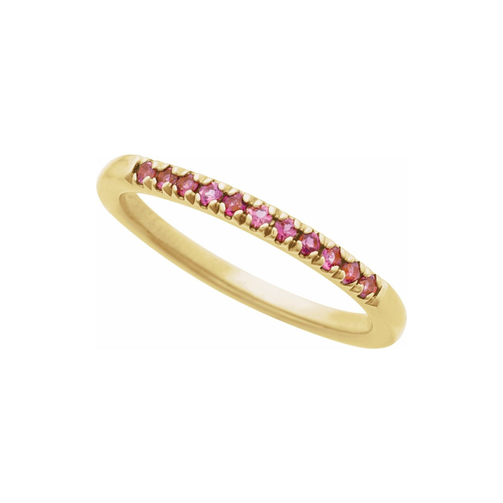 Gold ring with pink tourmalines on a white background
