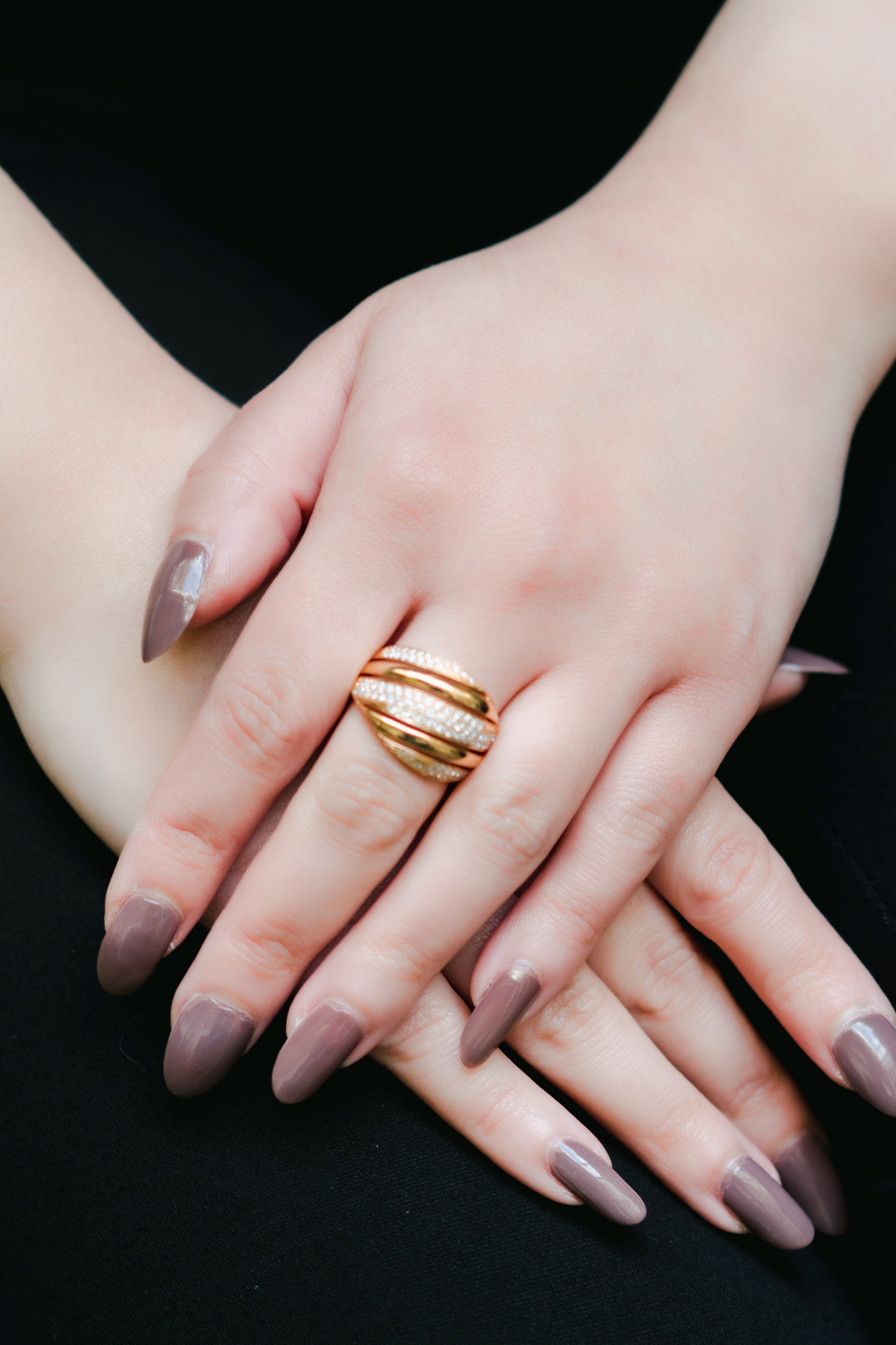 Rose gold thick band ring. Diamonds are set on the front. Looks striped.