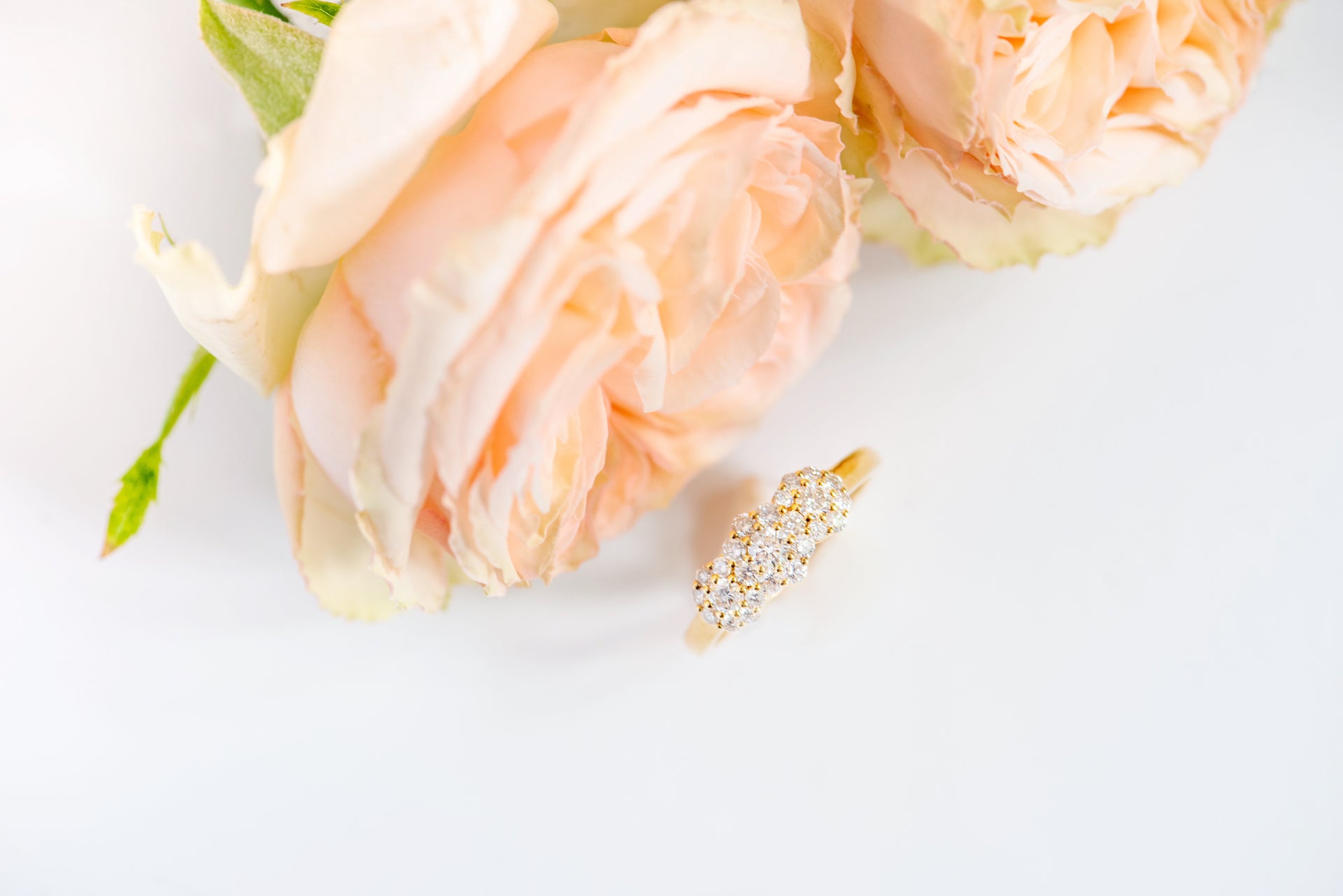 Yellow gold and diamond ring. Diamonds are in clusters that look like flowers. Three flowers. Dainty, vintage, timeless.