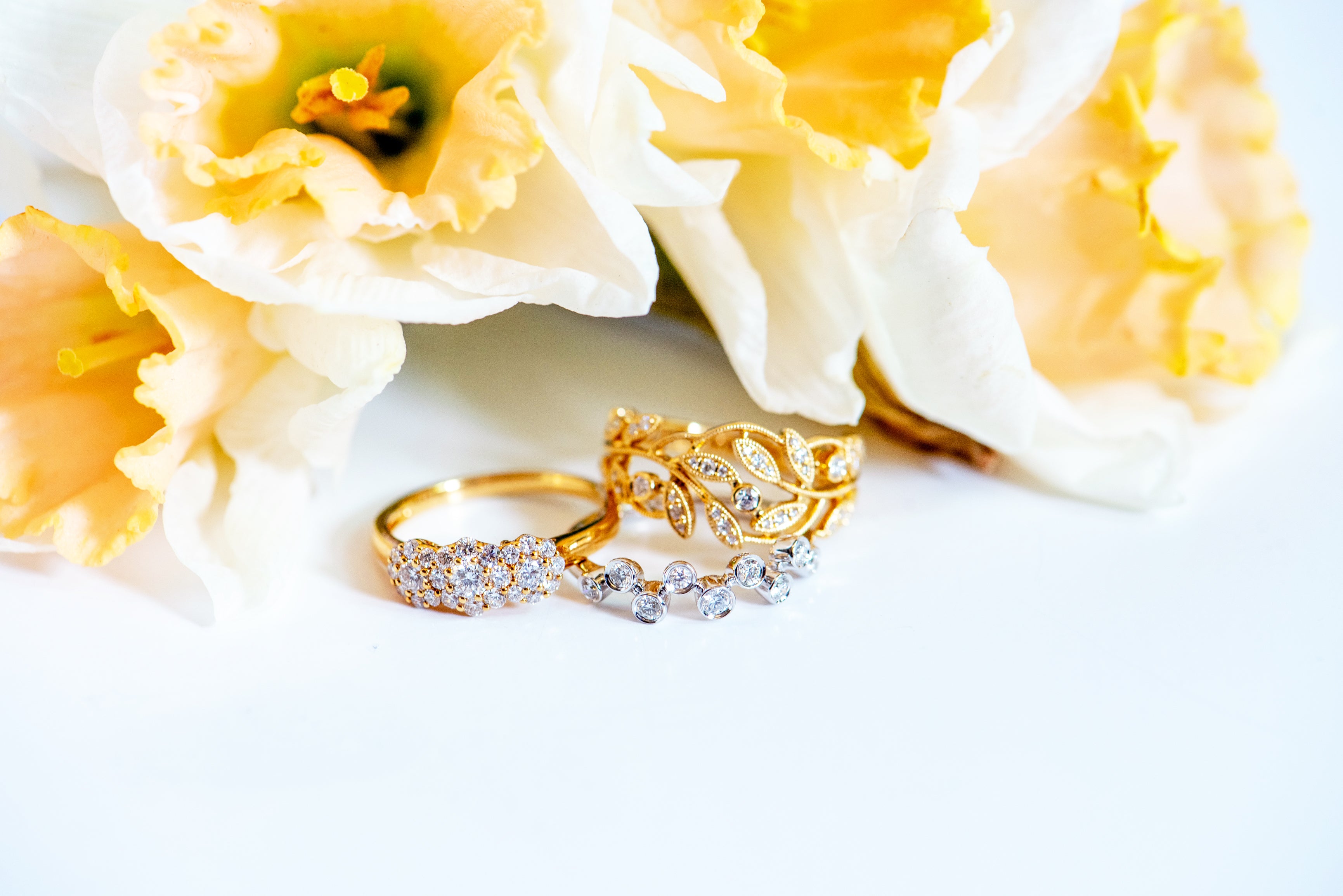 Yellow gold and diamond ring. Diamonds are in clusters that look like flowers. Three flowers. Dainty, vintage, timeless.