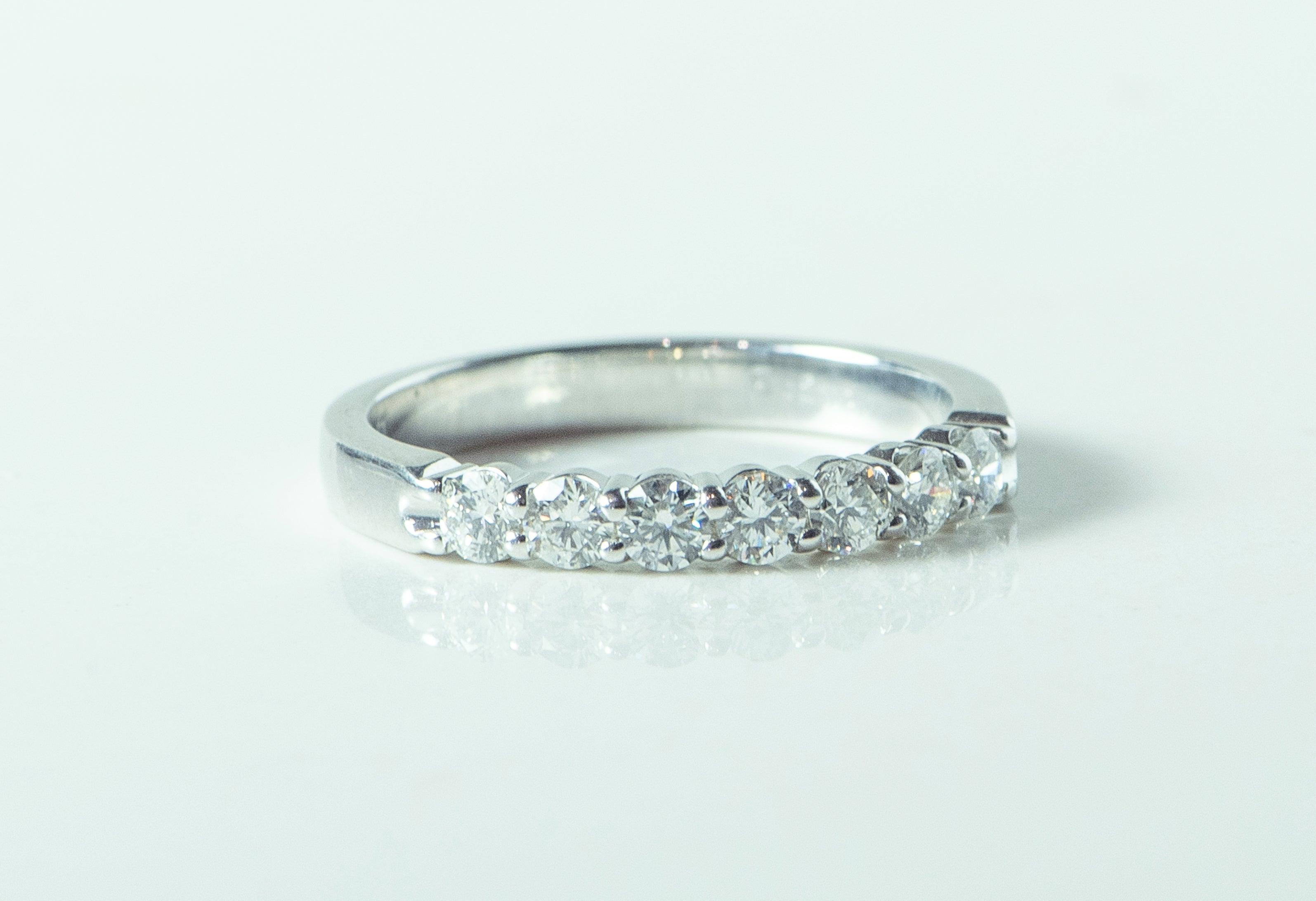 7 stone diamond and white gold ring. wedding band. shared prong set.