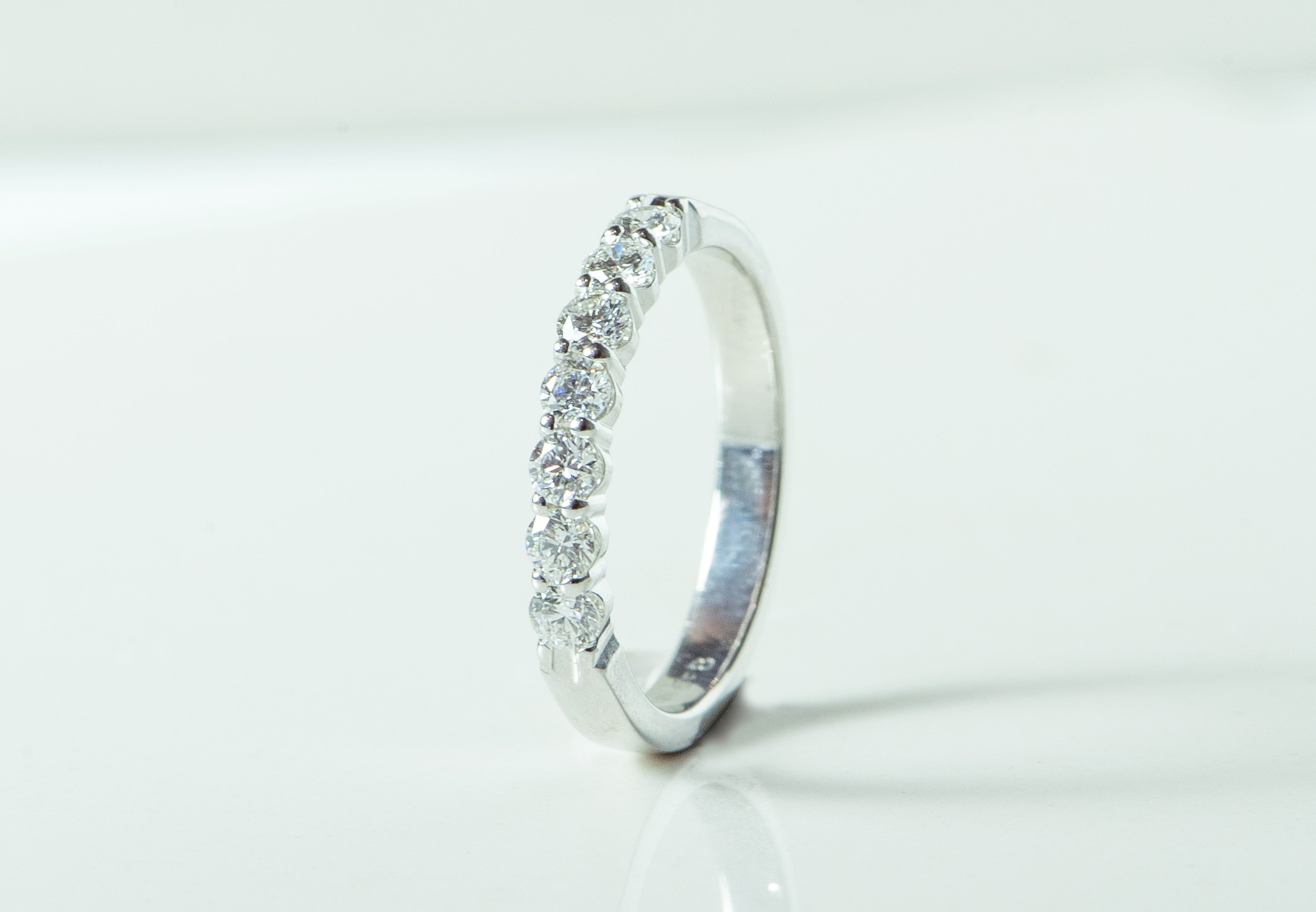 7 stone diamond and white gold ring. wedding band. shared prong set.