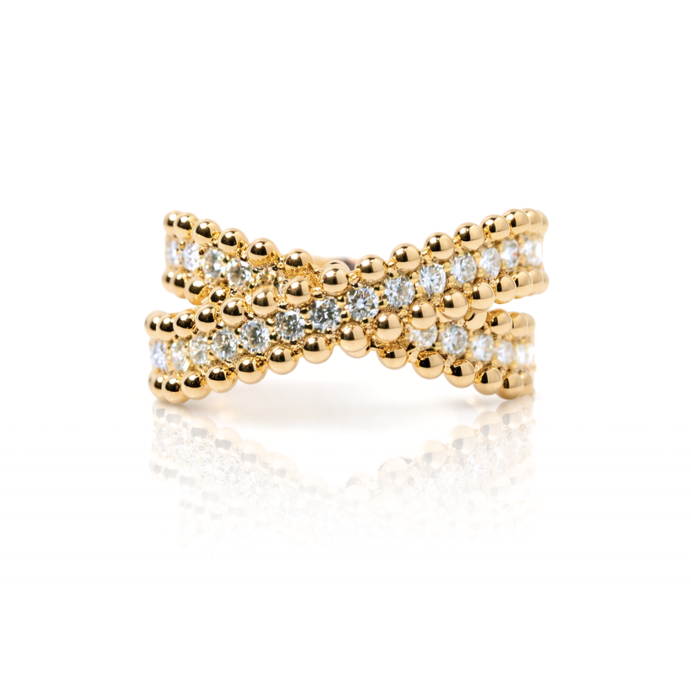 Gold cross-shaped ring with embedded diamonds on a white background