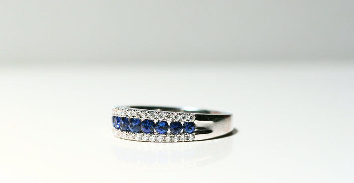 A white gold ring set with white diamonds and deep blue round sapphires. The sapphires look as though they're floating between the diamonds. The back of the ring is solid white gold. Local SF jewelry, San francisco, Luxury, hand made, Bay area, gift for her, gift for him. 