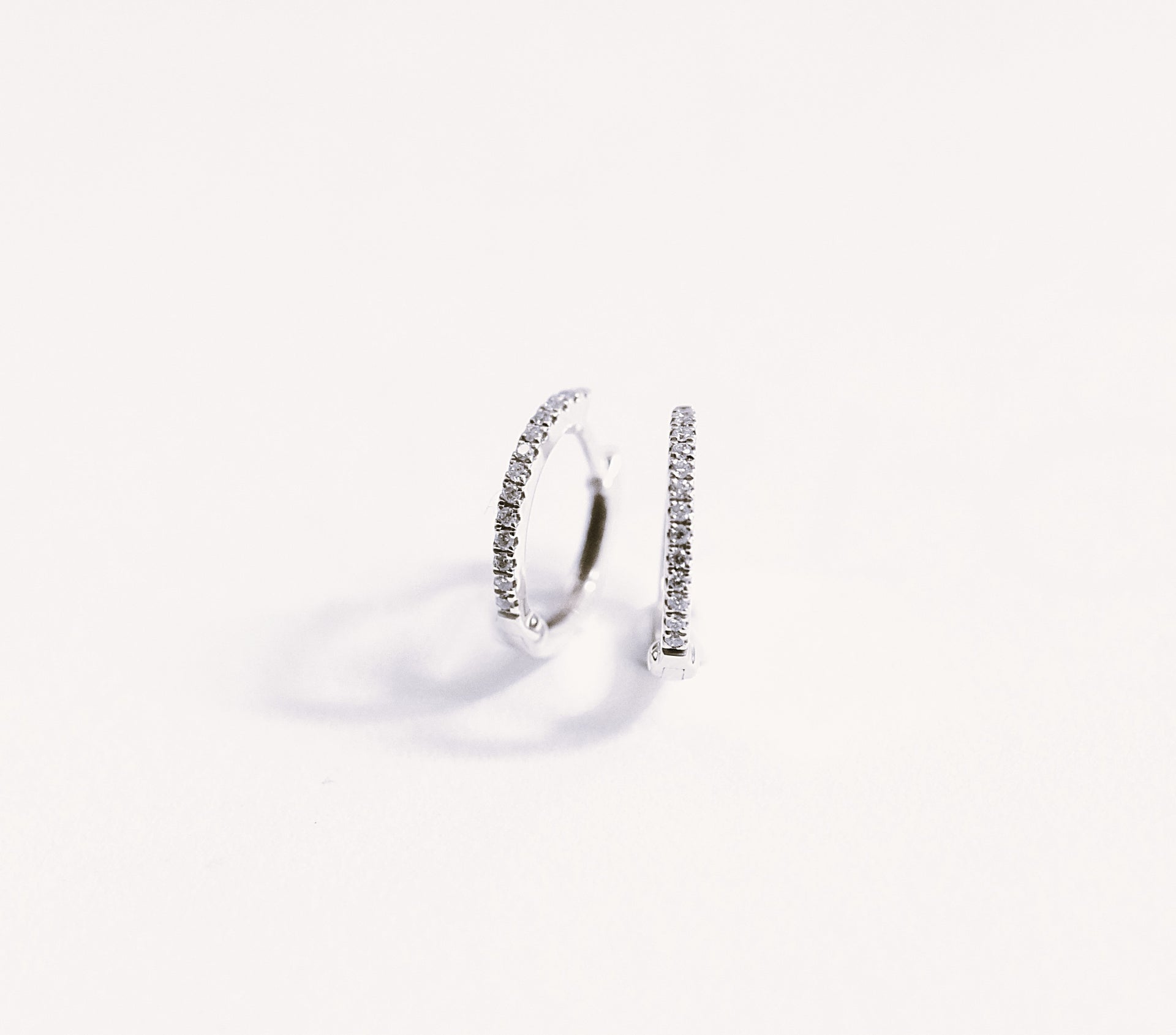 18k white gold diamond hoop earring on a white background