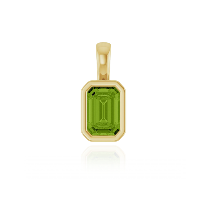 Gold pendant charm with a peridot gemstone on a white background