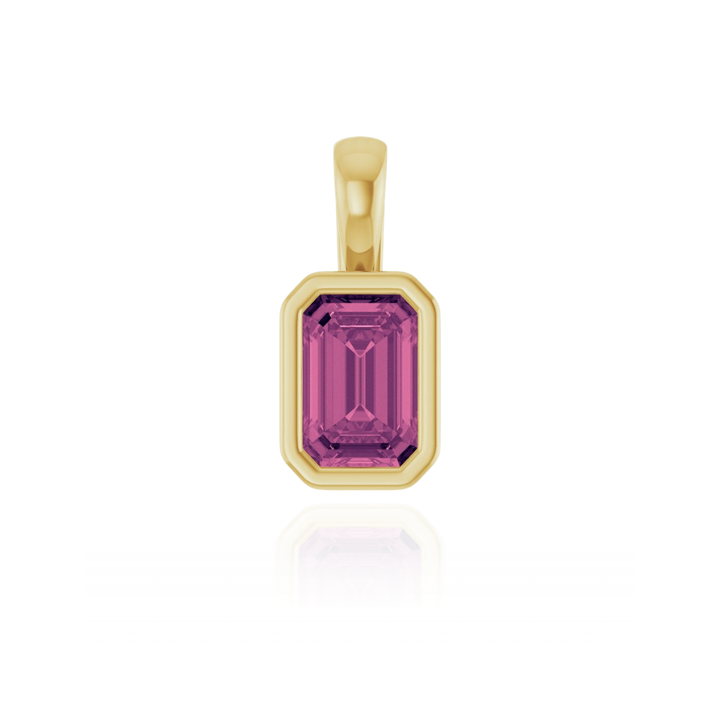 Gold pendant with a pink tourmaline gemstone on a white background