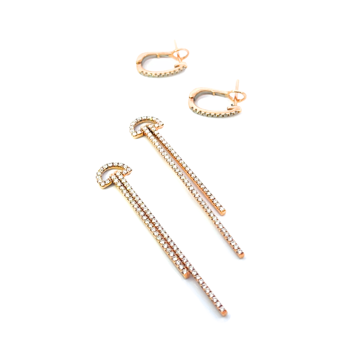 Rose gold earrings with diamonds on a white background