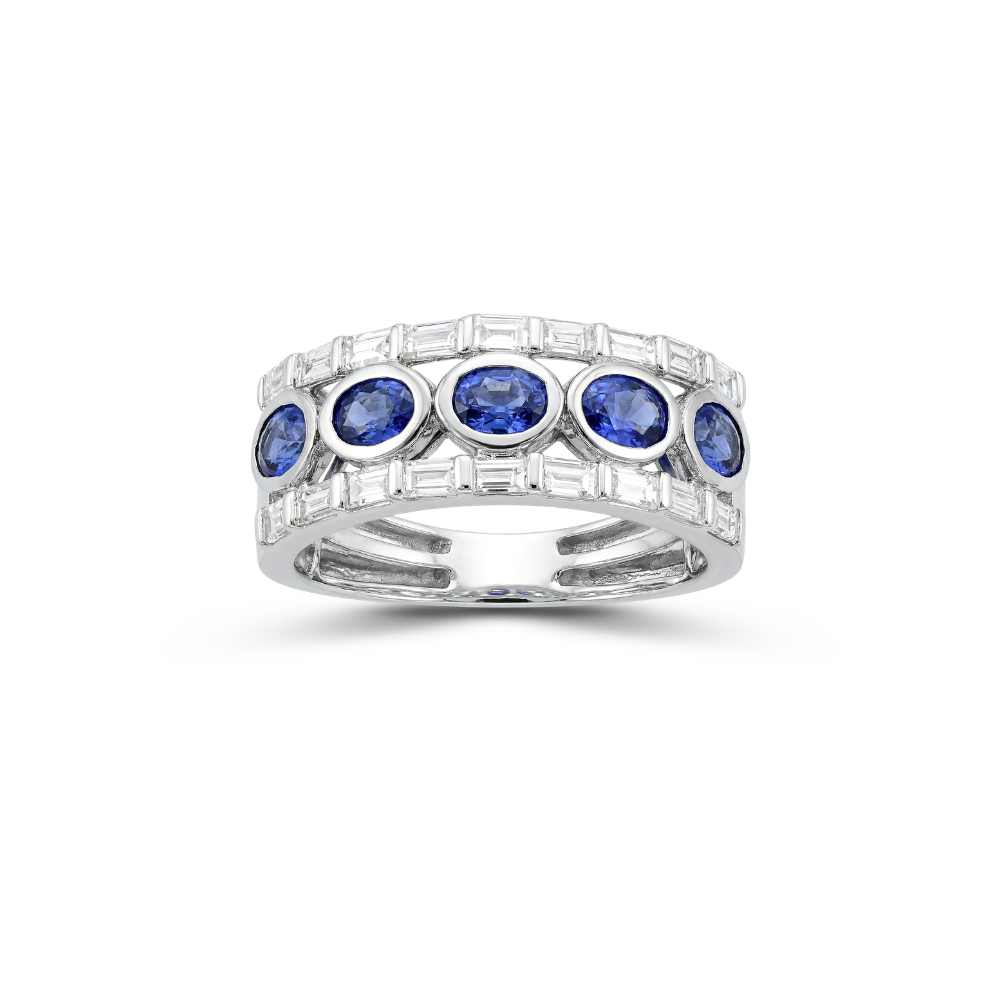 White gold ring with oval blue sapphires and baguette diamonds on a white background