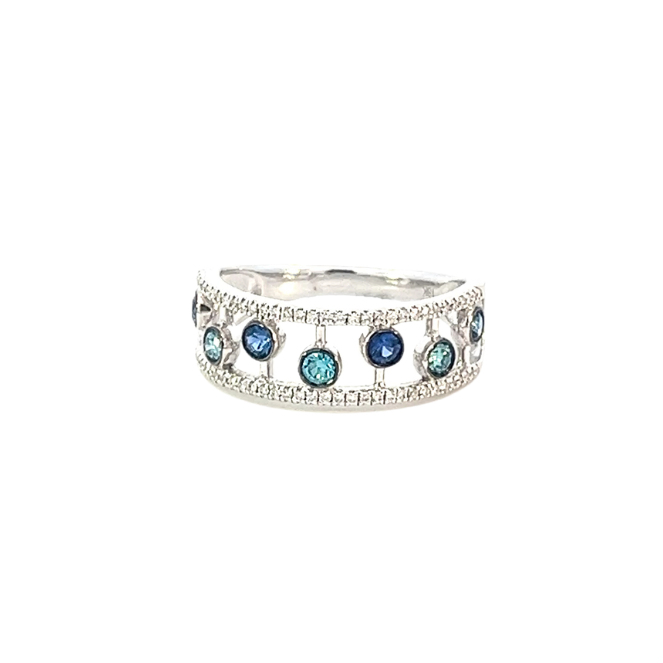 White gold ring with blue sapphires, blue diamonds, and diamonds on a white background