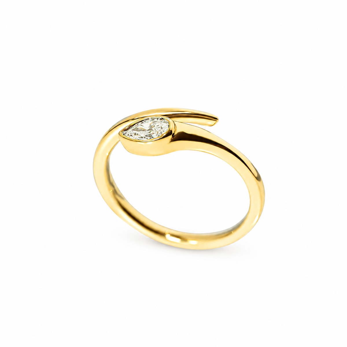 A yellow gold ring featuring a pear-cut diamond set in a curved, open snake design, photographed on a clean white background.