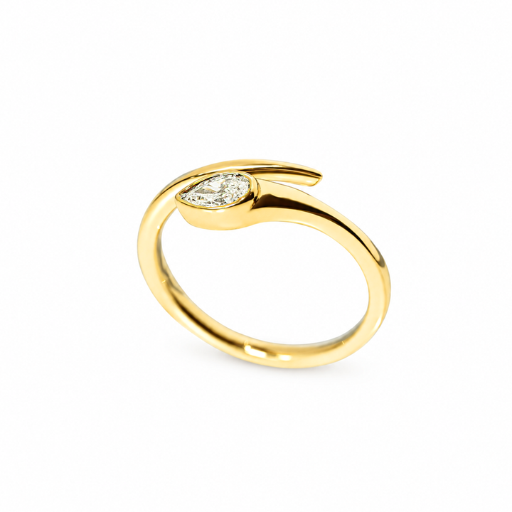 A yellow gold ring featuring a pear-cut diamond set in a curved, open snake design, photographed on a clean white background.