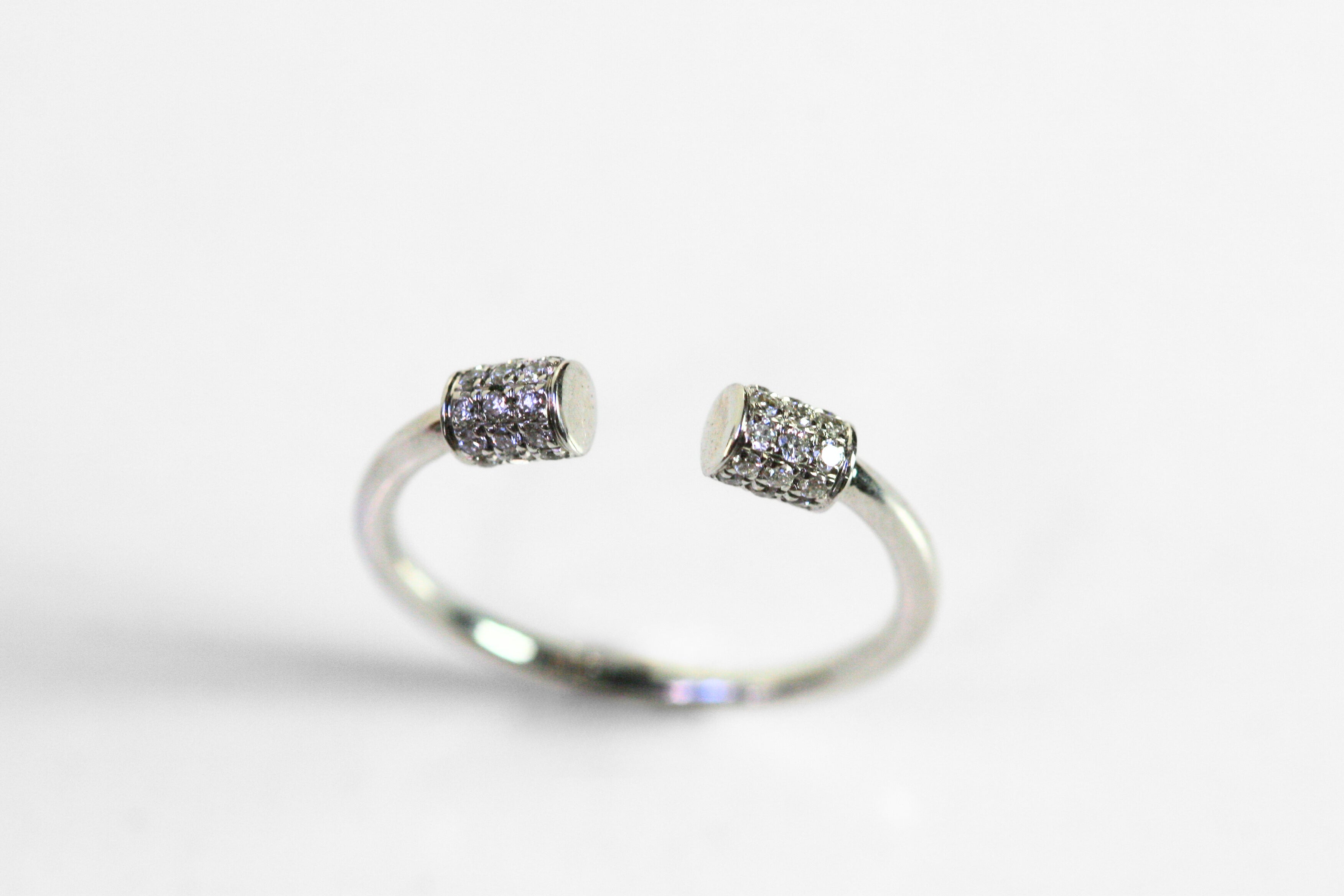 18k white gold ring. Cylinders covered in diamonds meet at the center of the finger, leaving a blank space open at the front of the ring. Diamonds are pave set. SF jewelry, local jeweler, luxury, fine jewelry, bay area, handmade, gift for her, birthday gift, anniversary gift