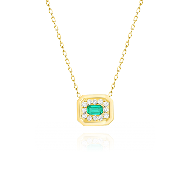 Gold necklace with emerald and diamonds on a white background