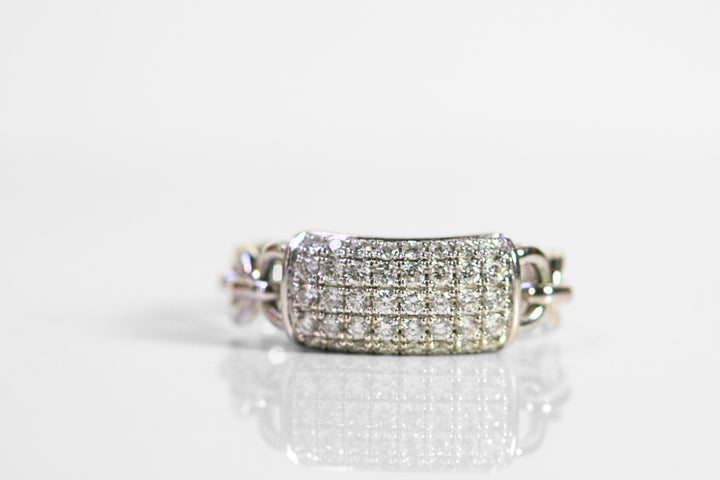 White gold ring. Front of the ring is a rectangle pave set with diamonds. The shank of the ring is a chain of white gold. 