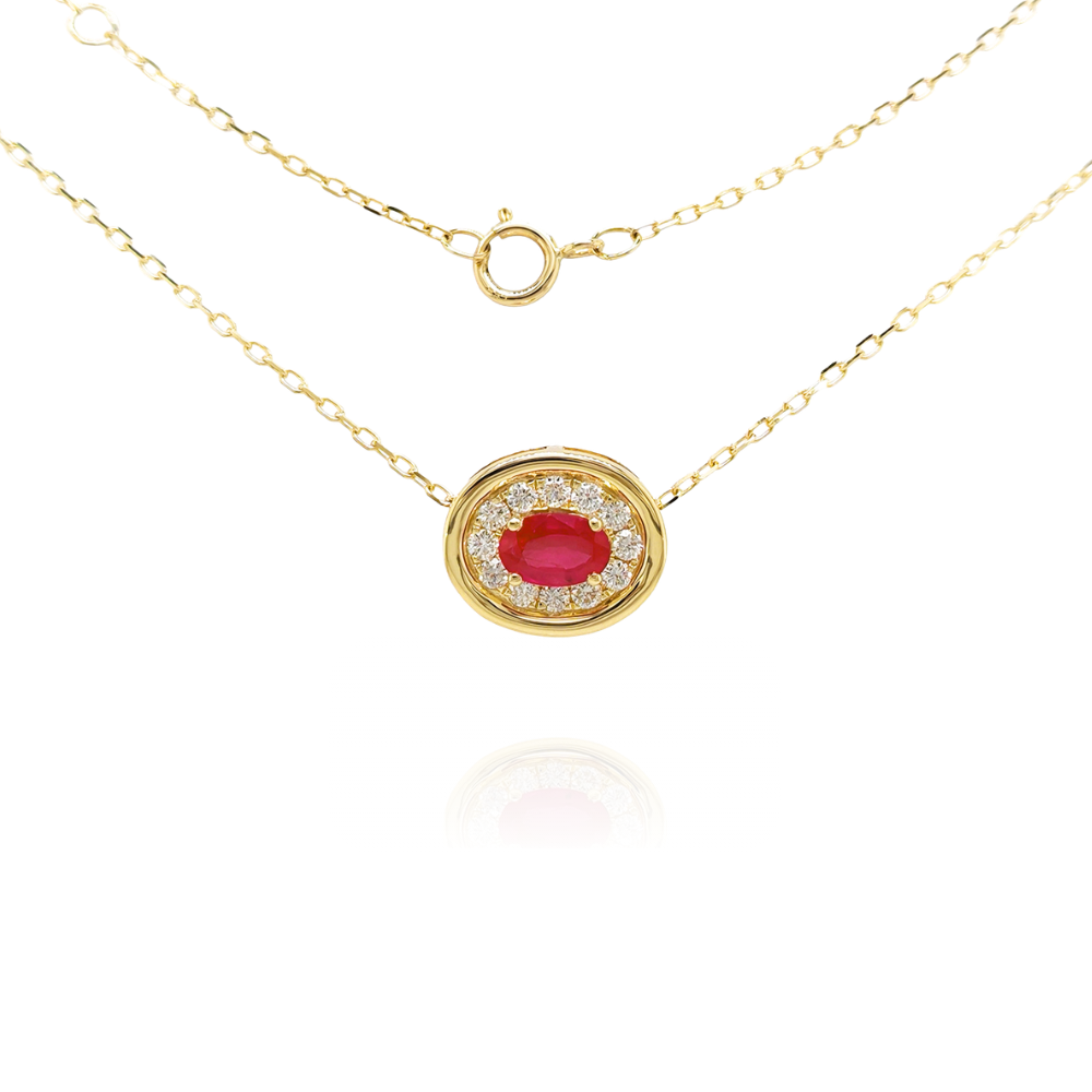 Gold necklace with a red ruby pendant on a white background