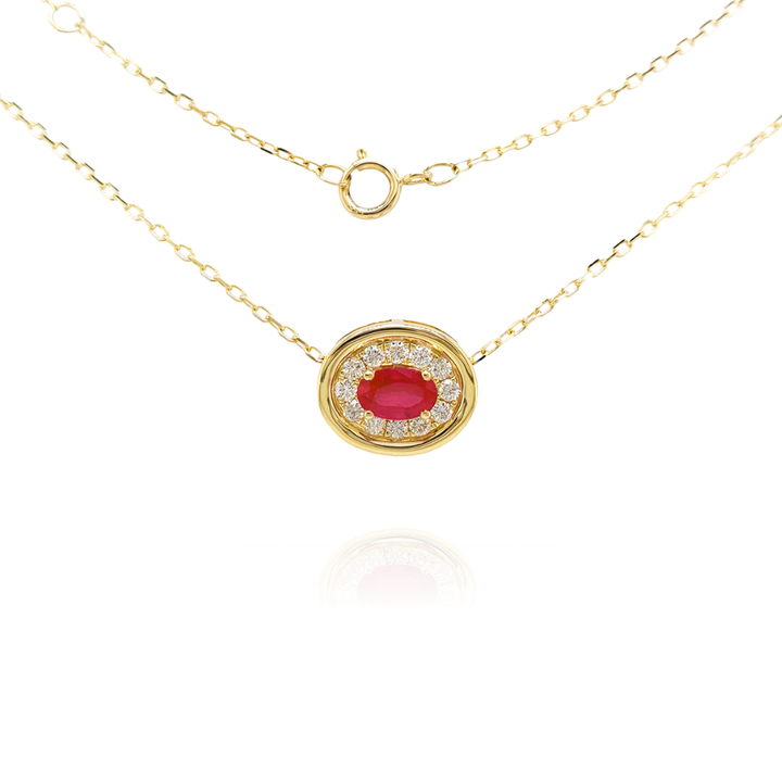 Gold necklace with a red ruby pendant on a white background