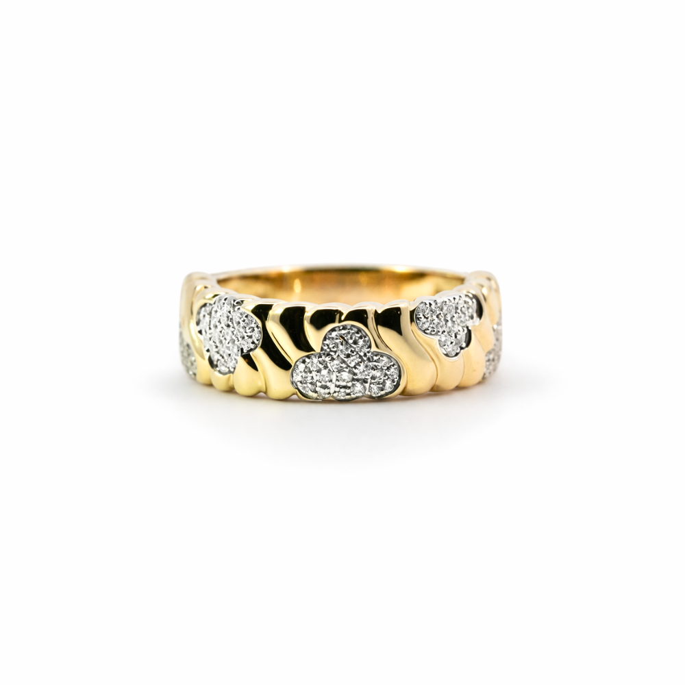 Gold ring with cloud-shaped diamond cutouts on a white background