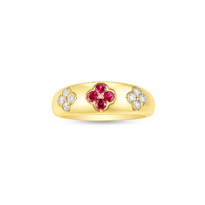 Gold ring with red ruby and diamond accents on a white background