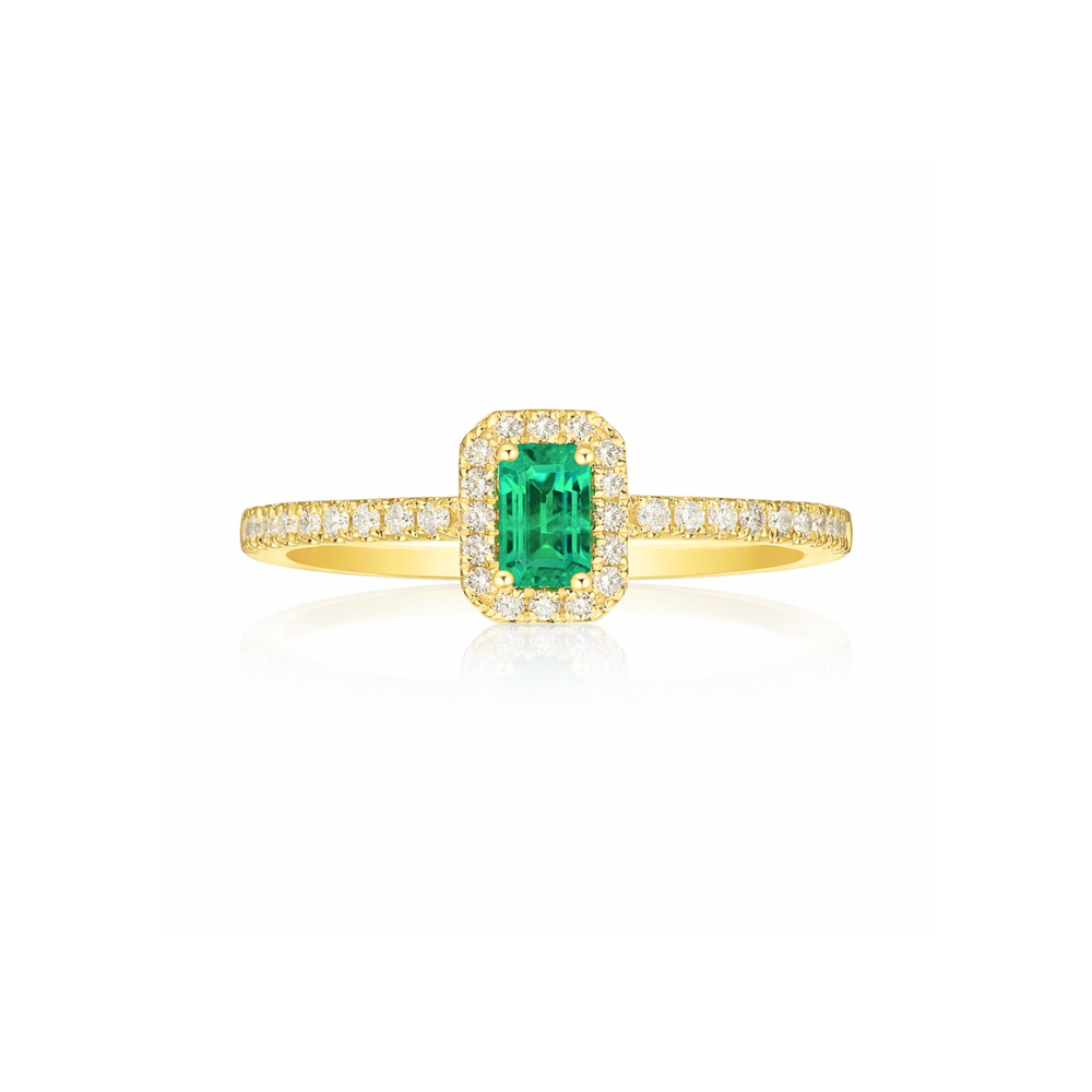 Gold ring with a green emerald and diamond accents on a white background