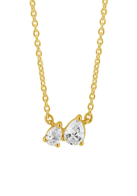A gold chain necklace with a pendant featuring two off-set, pear-cut diamonds in a gold setting, shown against a plain white background.
