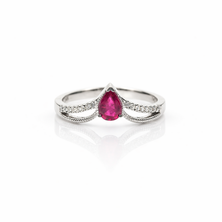 White gold ring with a ruby on a white background